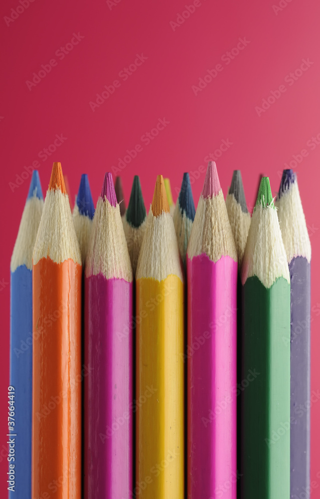 Fototapeta premium Colored Pencils on Red Background