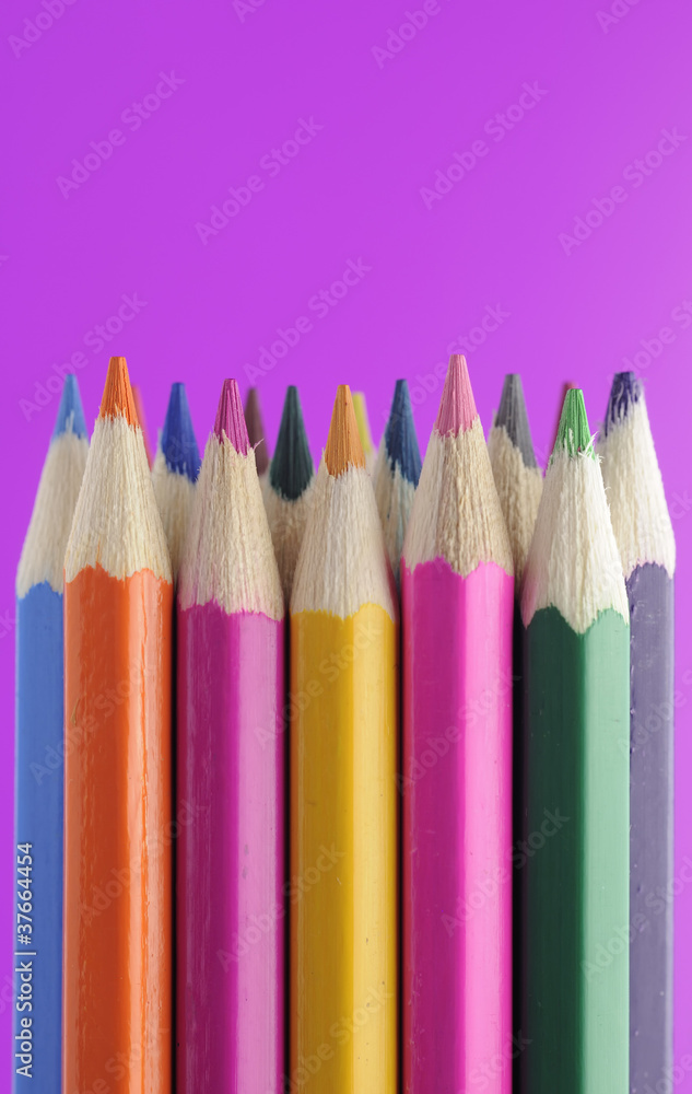 Fototapeta premium Colored Pencils on Bright Purple Background