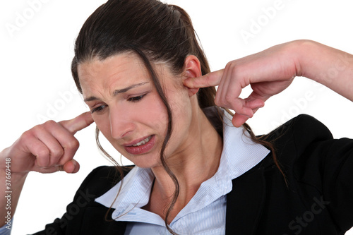 Woman being driven crazy by loud noise photo