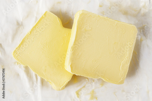 Piece of butter in paper on white background