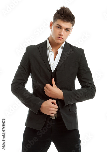 Young man posing in studio dressed in a business suit photo