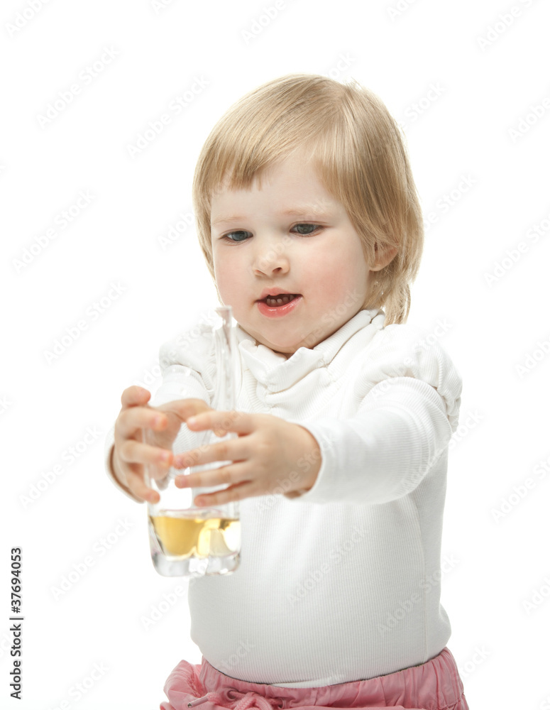The baby girl with a glass of juice. The baby girl with a glass of juice.