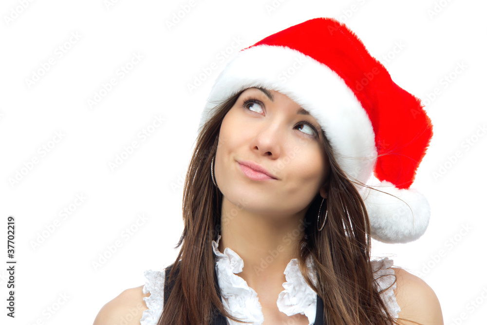 Beautiful woman in christmas santa claus red hat looking up Beautiful woman in christmas santa claus red hat looking up
