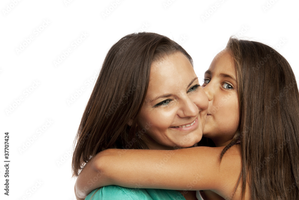 Little girl embracing and kissing her mother Little girl embracing and kissing her mother
