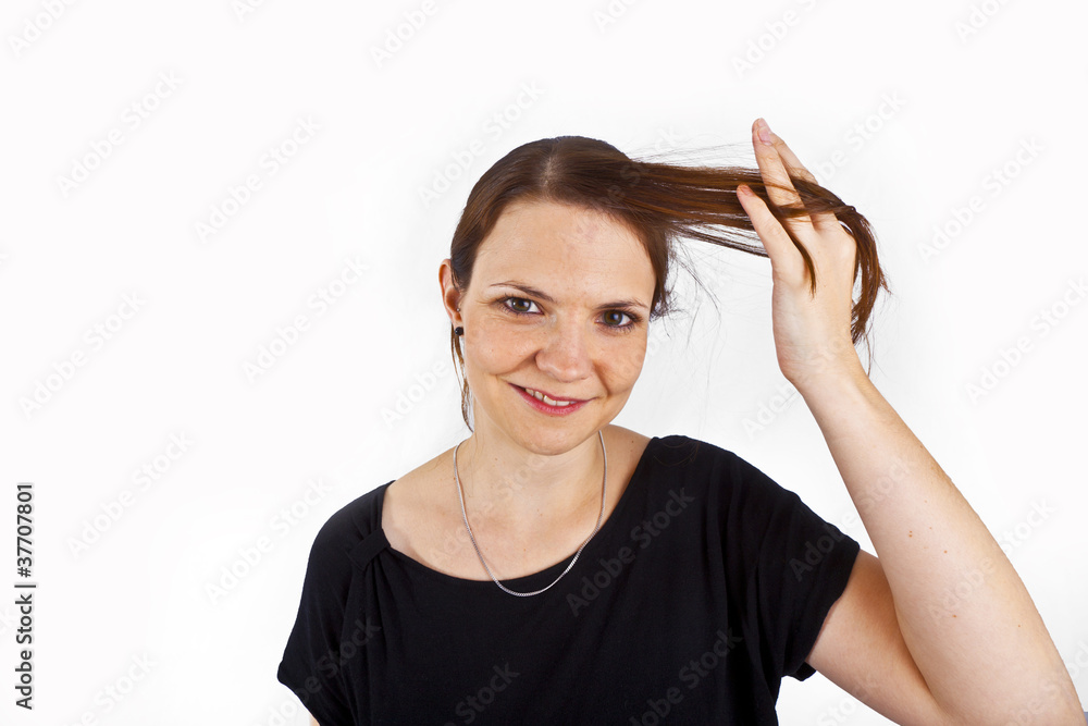 attractive young woman smiles and plays with her hair attractive young woman smiles and plays with her hair