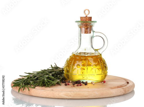 Oil in a bottle and fresh rosemaryon wooden board isolated photo