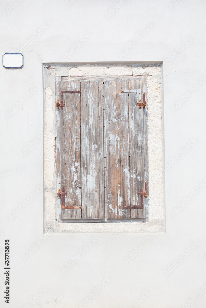 old window with closed wooden shutters