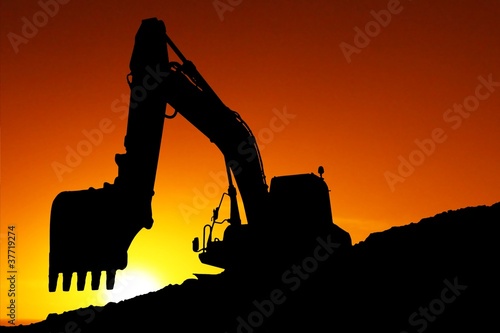 Silhouetted Digging Machine photo