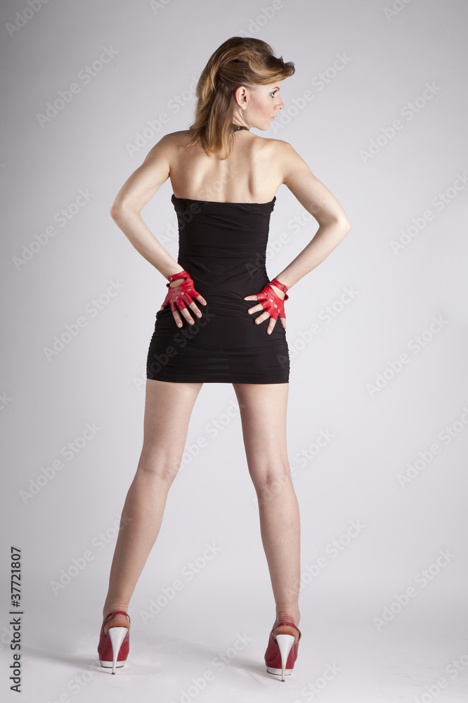 young girl in the little black dress posing in studio young girl in the little black dress posing in studio
