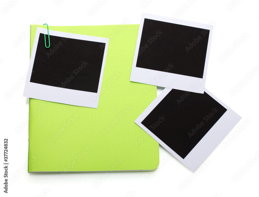 Photo papers and green notebook isolated on white Photo papers and green notebook isolated on white