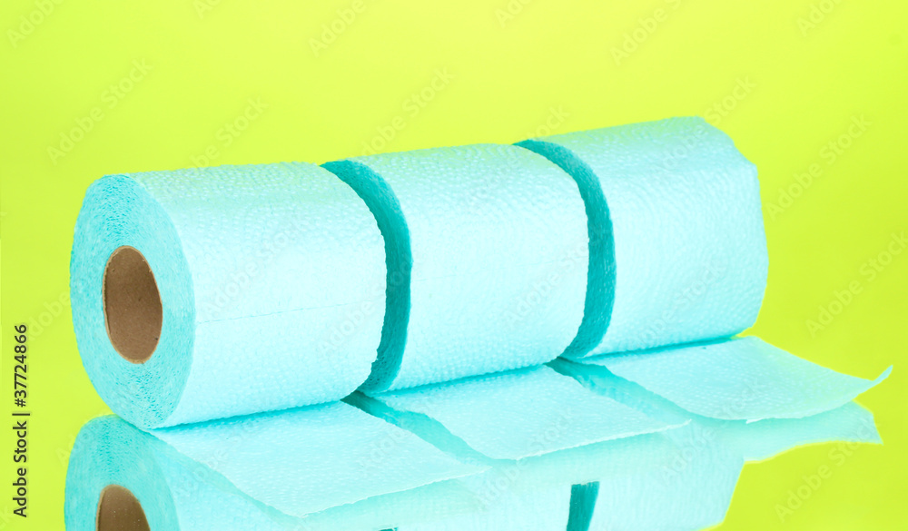 Obraz premium blue rolls of toilet paper on green background