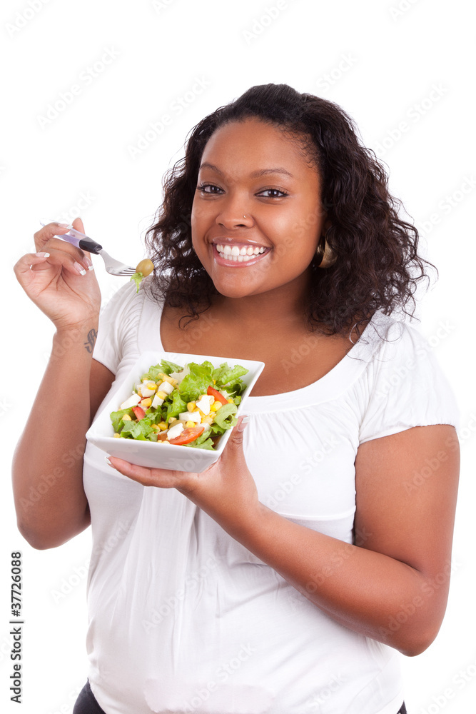 Young african american woman eating salad Young african american woman eating salad