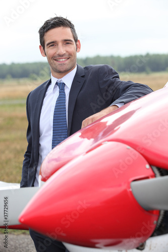 Pilot next to plane photo