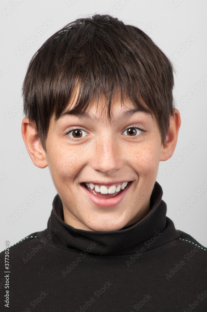 Portrait of smiling boy with surprised look on his face