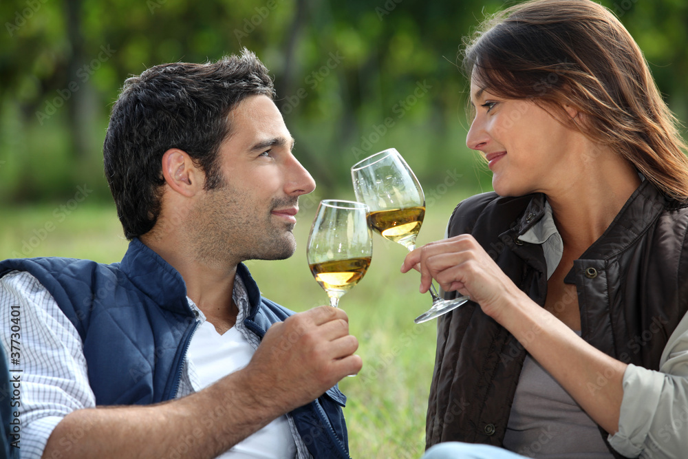 Couple drinking wine in field Couple drinking wine in field