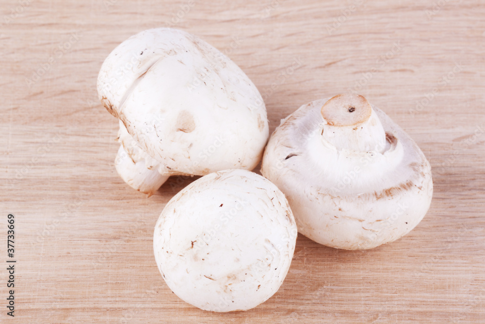 Fresh mushrooms on the wooden breadboard Fresh mushrooms on the wooden breadboard