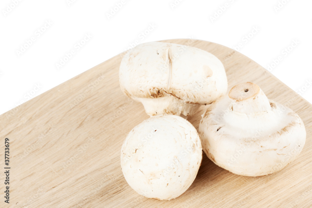 Fresh mushrooms on the wooden breadboard