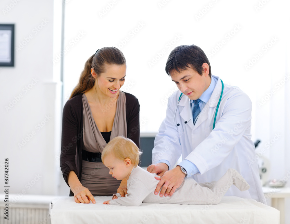 Cute baby being checked by a pediatric doctor Cute baby being checked by a pediatric doctor