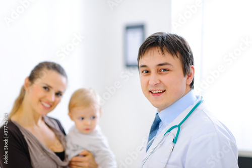 Portrait of pediatric doctor and smiling mother with lovely baby