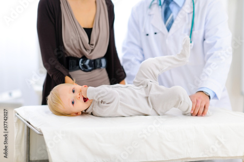 Portrait of a cute baby laying on table at pediatricians cabinet
