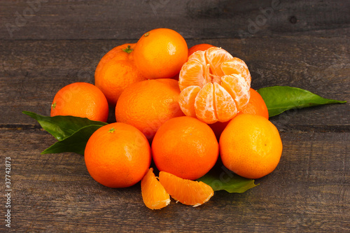 tangerines with leaves on wooden grey table