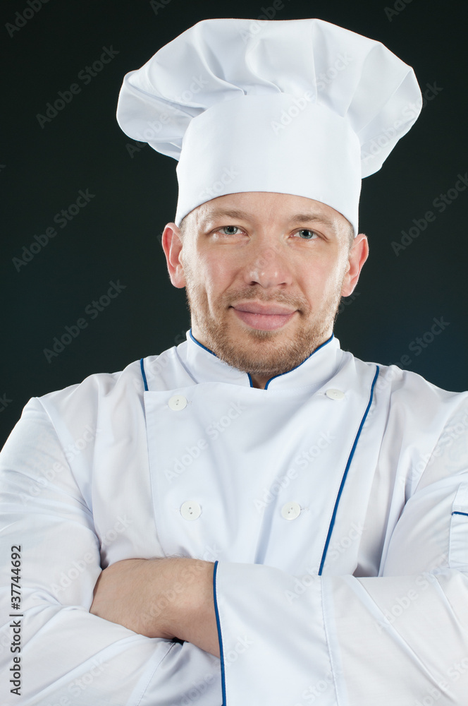 Confident chef with his arms crossed, studio shot