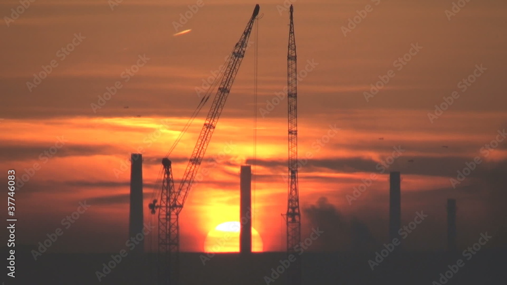 cranes and industry in a morning sunrise cranes and industry in a morning sunrise