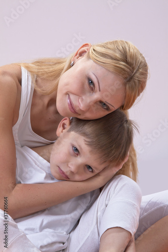 A beautiful young mother with her son rest during exercise yoga