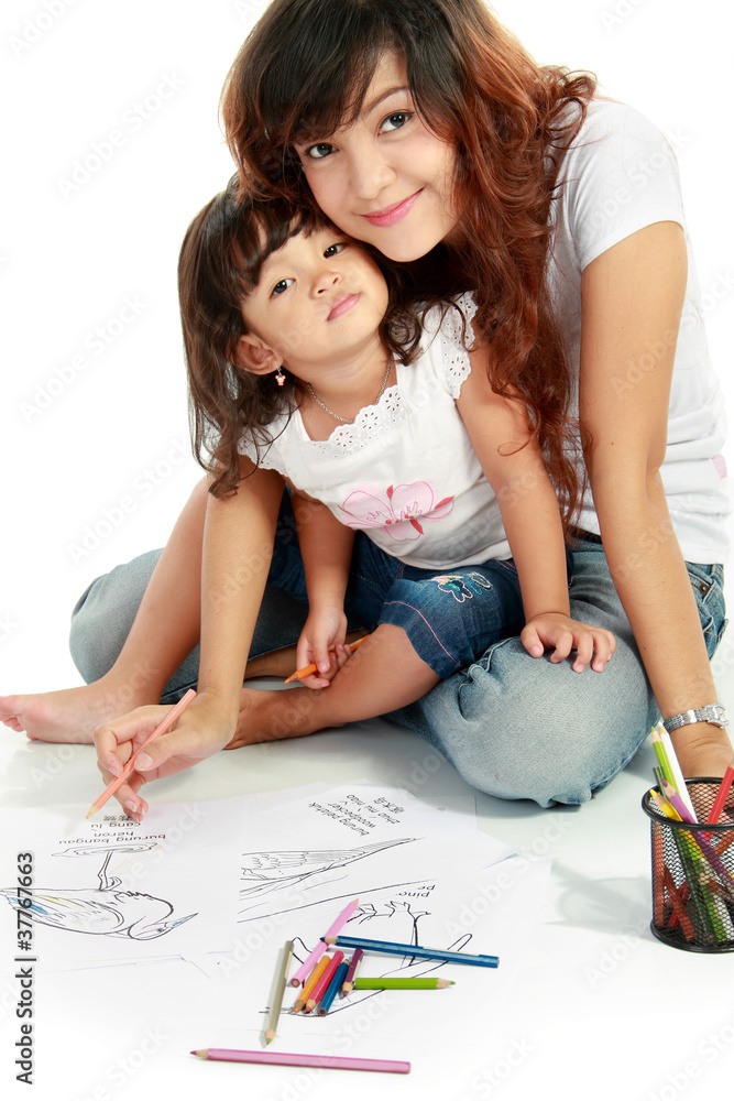mom and her little daughter drawing together mom and her little daughter drawing together
