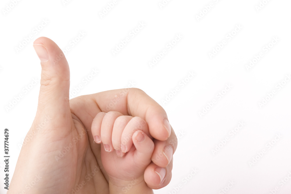 Close-up of baby's hand holding mother's finger Close-up of baby's hand holding mother's finger