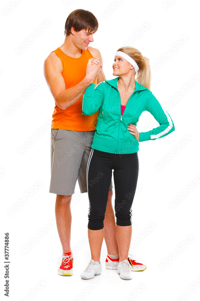 Happy male athlete and fitness young woman handshaking Happy male athlete and fitness young woman handshaking