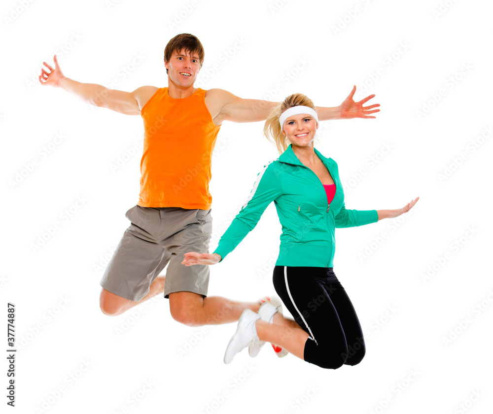 Fitness girl and man in sportswear jumping isolated on white Fitness girl and man in sportswear jumping isolated on white