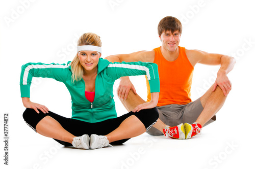 Woman and man in sportswear doing stretching exercise