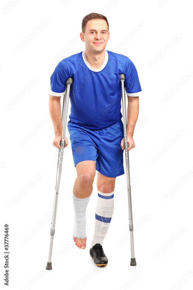 Full length portrait of an injured soccer football player on cru Full length portrait of an injured soccer football player on cru