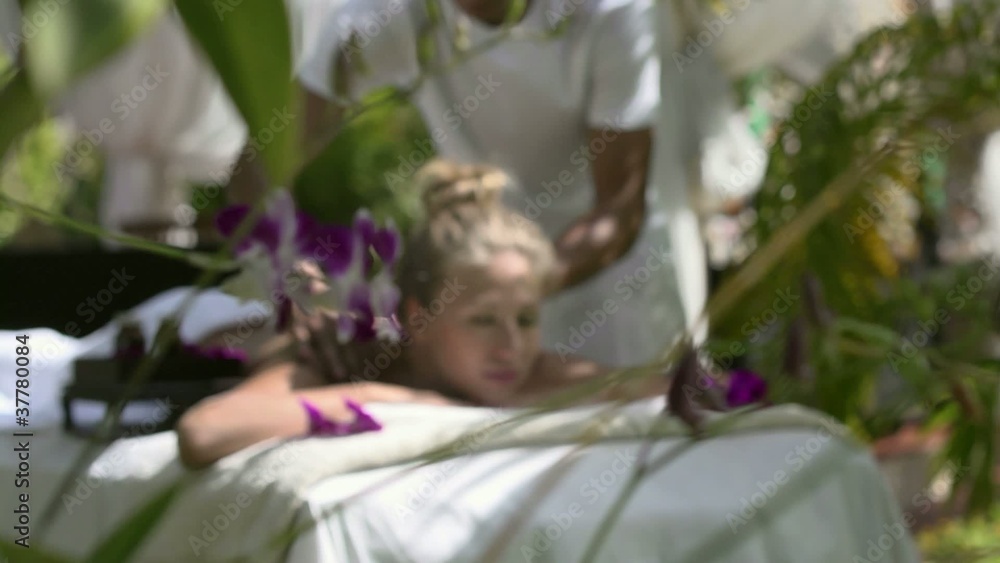 Happy young woman smiling during massage in spa Happy young woman smiling during massage in spa