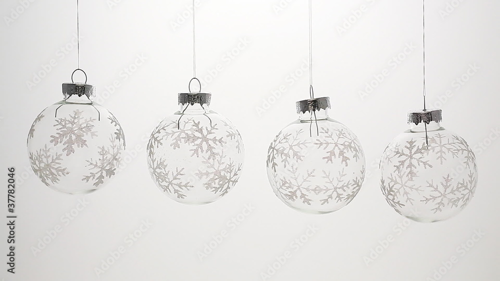 The glass Christmas Balls turns on a light background The glass Christmas Balls turns on a light background