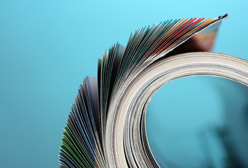 Rolled up magazines on blue background