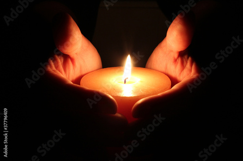 Candle between hands