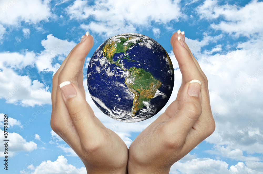 Human hands holding planet Earth against blue sky - Environmenta - obrazy, fototapety, plakaty 