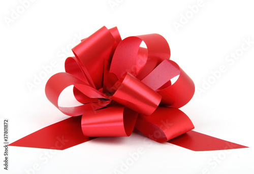 Single red ribbon plastic gift bow isolated on white background.