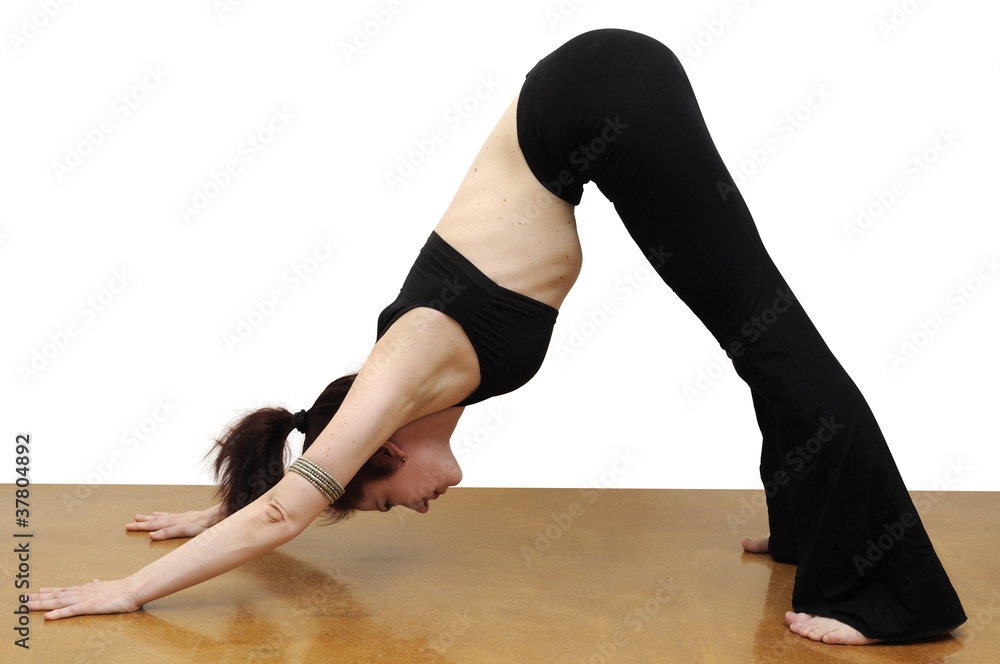 Woman in yoga Downward Facing Dog position Woman in yoga Downward Facing Dog position