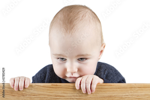 young child holding wooden board photo