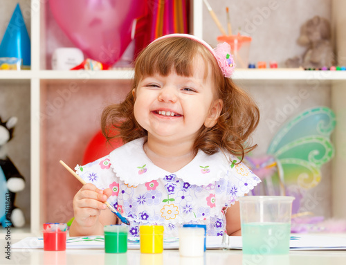 little girl paints paints