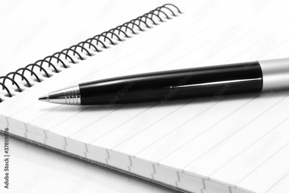Notepad with ball pen on a white background Notepad with ball pen on a white background