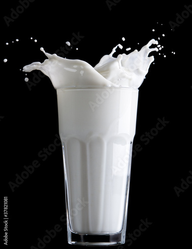 Fototapeta milk splash on black background