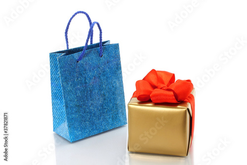 Shopping bag and gold present on a white background