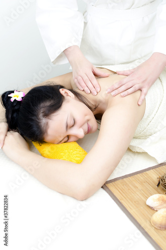 Young lady receiving back massage at spa center