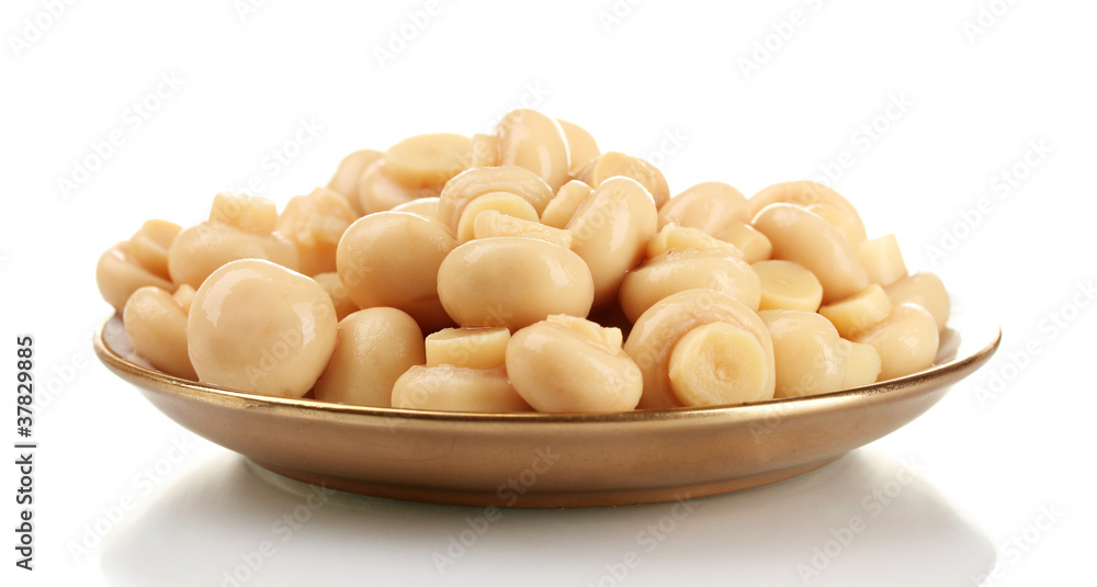 Marinated mushrooms in brown saucer isolated on white Marinated mushrooms in brown saucer isolated on white