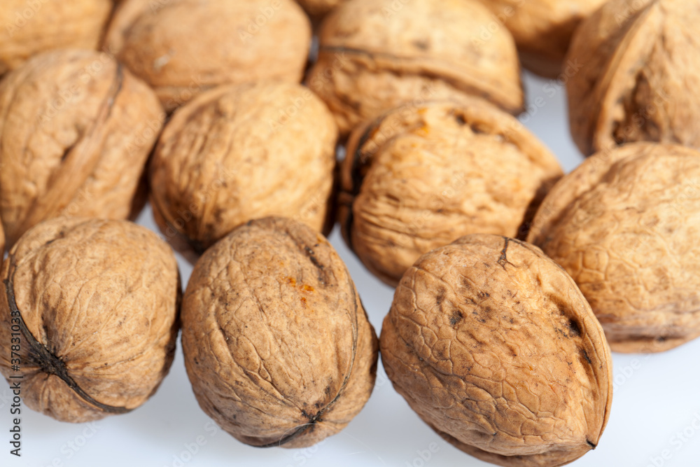Close up of many scattered walnuts. Background. Close up of many scattered walnuts. Background.