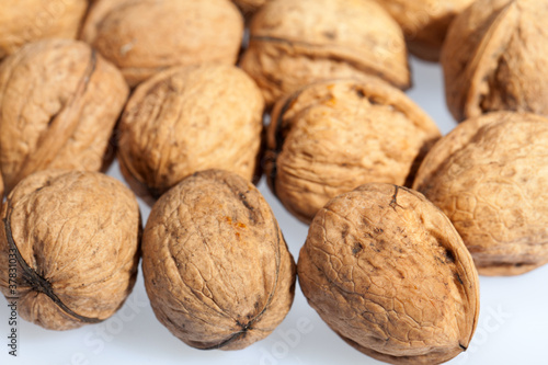 Close up of many scattered walnuts. Background.